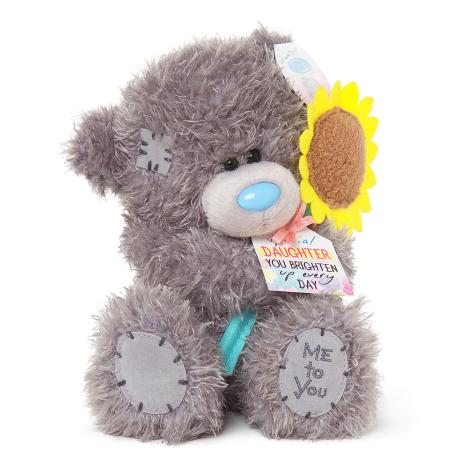 Teddy bear holding store a sunflower